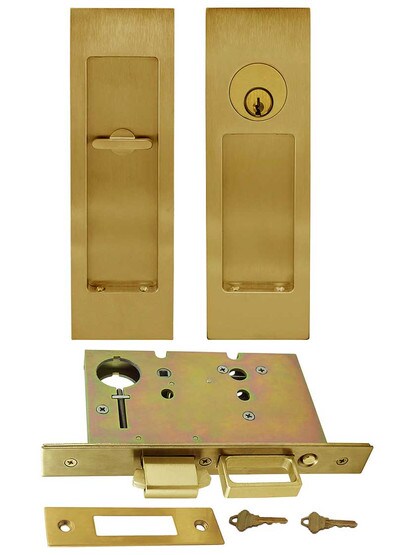 Premium Keyed Pocket-Door Mortise Lock Set with Rectangular Pulls in Aged Brass.